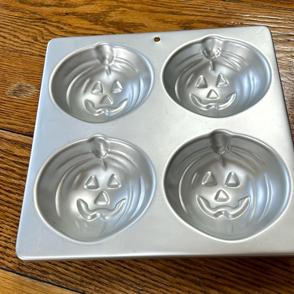 Wilton 4 in 1 Jack-O-Lantern Halloween theme molds/cake pans.  Dated 1990.